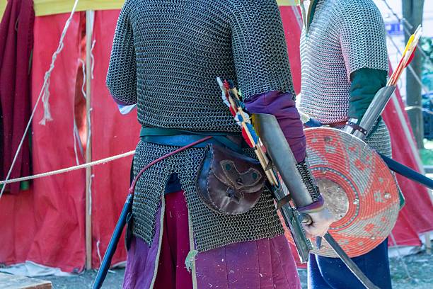 istock A group of reenactors in historical medieval chainmail armor with bows and shields at an outdoor festival 2239878809