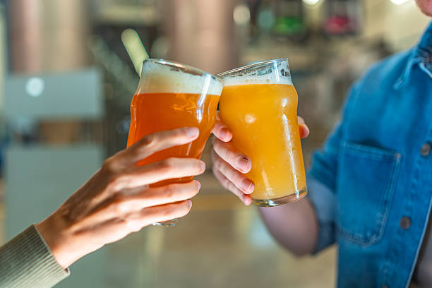 istock People cheersing with craft beer glasses inside brewery 2239879062