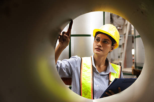 istock Female engineer inspecting metal coil surface in factory 2239879365