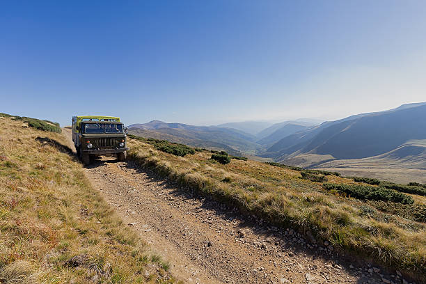 istock Excursion truck on a mountain road 2239880078