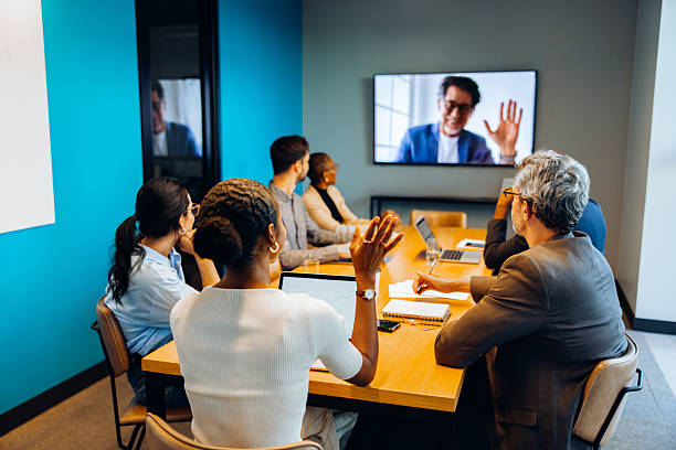 istock Meeting attendees engage with a virtual presenter during a conference 2239880118
