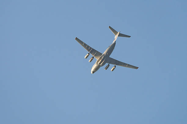 istock A large transport plane is flying in the sky on a sunny day 2239880162