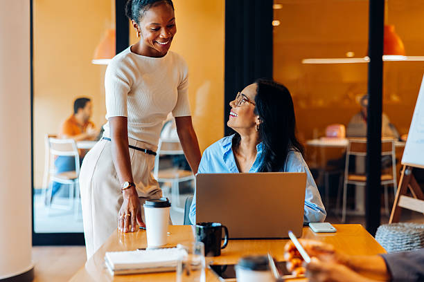istock Two professional women interacting positively in an office environment 2239880313