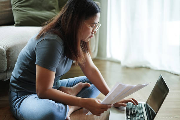 istock Woman checking financial papers at home 2239880337