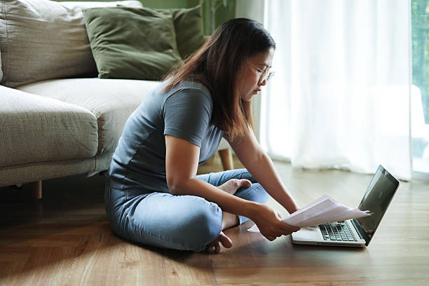 istock Woman checking financial papers at home 2239880341