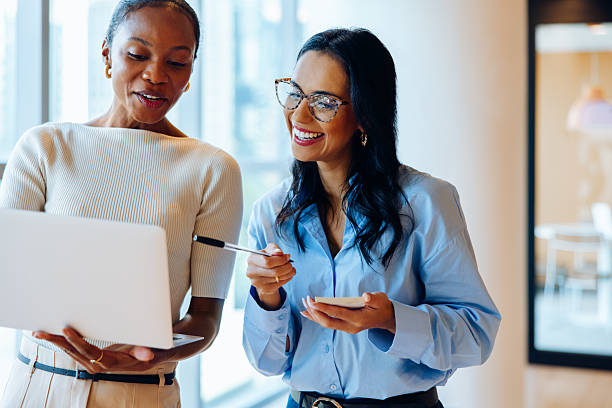 istock Two women sharing ideas and discussing a project on a laptop 2239880379