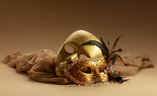 istock Golden Venetian carnival masks on a beige background. 2239880496