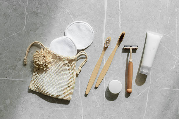 istock Hygiene products as bamboo toothbrushes, toothpaste, reusable pads, safety razor on grey marble background with natural light, eco-friendly items for self care, zero waste concept. Minimal top view 2239881895