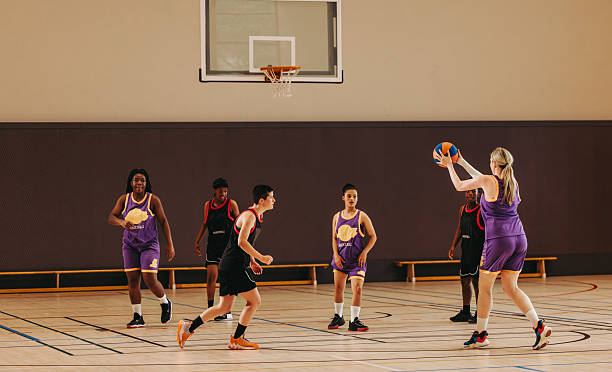 istock Focused on the goal: Female basketball player takes aim for a three-pointer 2239882168