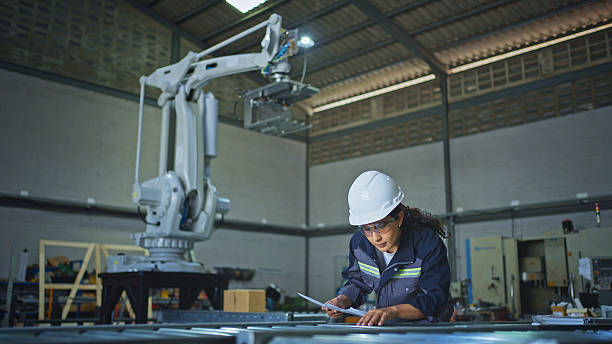 istock Female engineer is working with an automatic roller conveyor system in the factory. 2239883966