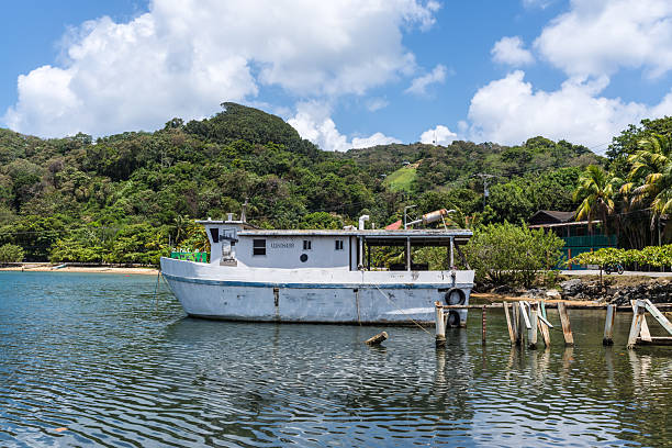 Isla de Roatan, Honduras - April 16, 2024: A small ship is moored in Roatan Island, Honduras.