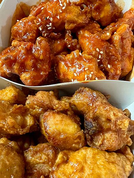 Crispy Korean fried chicken, perfectly glazed with a sweet and spicy sauce. Ideal for food photography and menus, showcasing the irresistible crunch and flavor of this beloved dish.