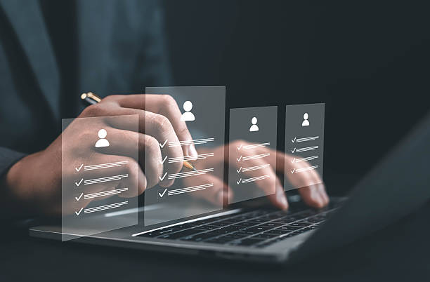 istock Business professional using a laptop to evaluate candidate profiles with digital checklists, representing recruitment process, human resource management, and online employee evaluation in modern 2239889046