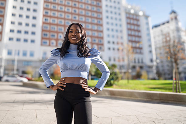 istock Confident young black woman posing in city 2239890108