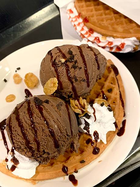 Crispy, golden waffles topped with creamy ice cream, creating a perfect balance of warm and cold, crunchy and smooth. A delightful dessert or breakfast treat, with toppings like fruits or syrup.