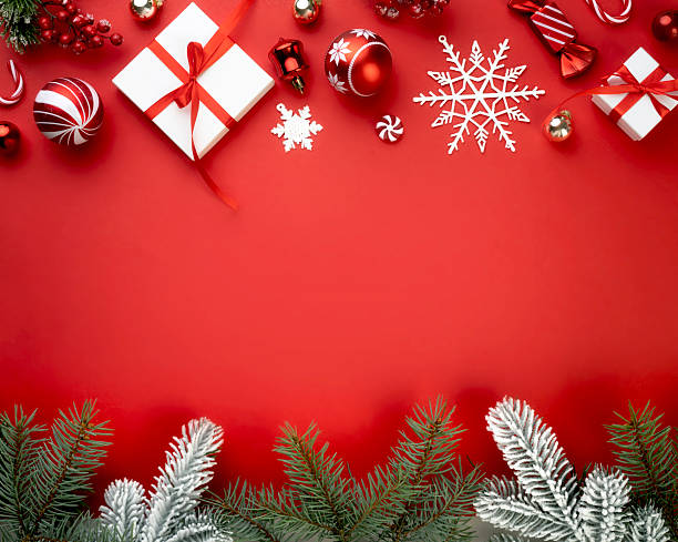 istock Red square Christmas decorated background, xmas frame composition of balls,fir tree branches and gift boxes. Holiday banner,wallpaper. 2239893325