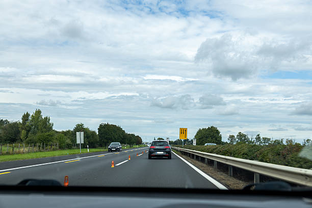 istock Highway traffic with lane closure and roadwork cones 2239893333