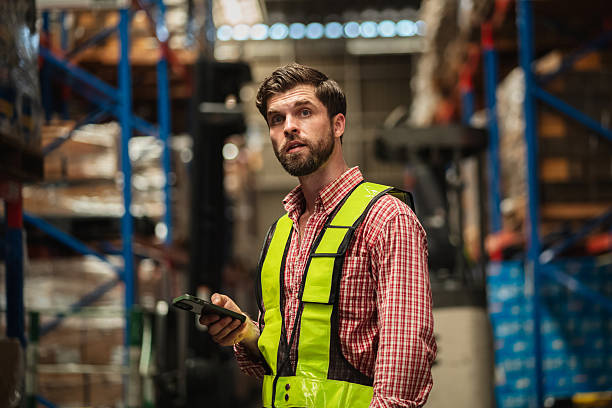istock Warehouse worker working and checking the stock in the warehouse. Factory manager using digital tablet check barcode in industry factory logistic. 2239893964