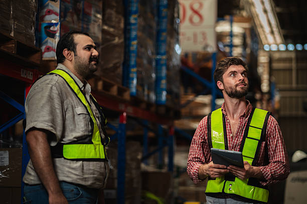 istock Warehouse worker working and checking the stock in the warehouse. Factory manager using digital tablet check barcode in industry factory logistic. 2239894662