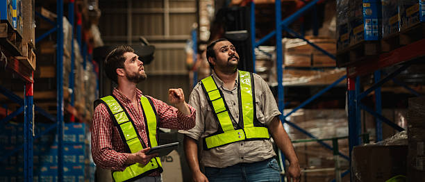 istock Warehouse worker working and checking the stock in the warehouse. Factory manager using digital tablet check barcode in industry factory logistic. 2239895000