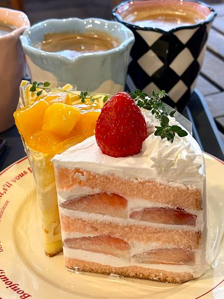 istock A delightful assortment of desserts displayed in a cozy cafe setting, featuring cakes, pastries, and sweet treats on elegant plates, creating a warm and inviting atmosphere. 2239895040