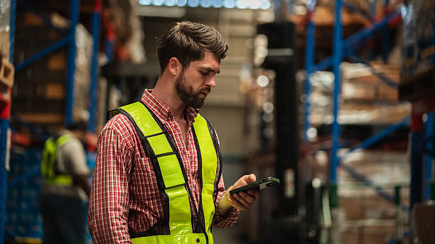 istock Warehouse worker working and checking the stock in the warehouse. Factory manager using digital tablet check barcode in industry factory logistic. 2239895081