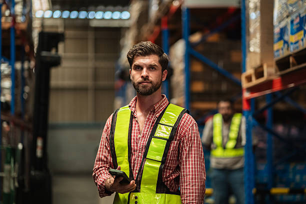 istock Warehouse worker working and checking the stock in the warehouse. Factory manager using digital tablet check barcode in industry factory logistic. 2239895121