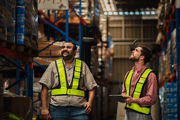 istock Warehouse worker working and checking the stock in the warehouse. Factory manager using digital tablet check barcode in industry factory logistic. 2239895295