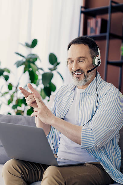 istock Confident professional man communicating online from his modern home office space 2239898383