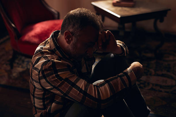 istock Man with depression and headache at home. 2239900799
