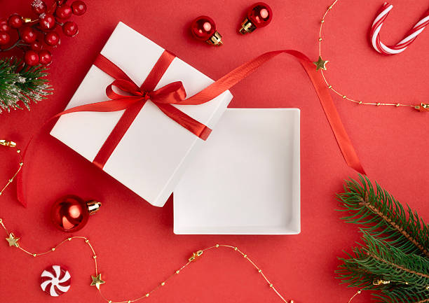 Top view white square box on red christmas decorated background,product promotion display,template. Xmas new year mockup.