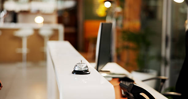 Bell, hotel or front desk for room service, accommodation or alarm buzzer at reception or entrance. Night, counter and resort with chime, sound or signal for hospitality, guest or visitor information