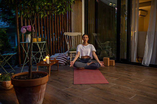 istock Young Woman Meditating Outdoors in a Comfortable Relaxing Atmosphere at Dusk 2239905038