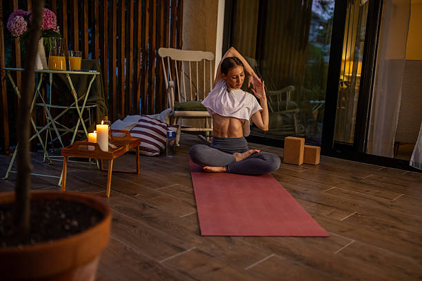 Tranquil Yoga Session in Cozy Indoor Setting with Candlelight Ambiance