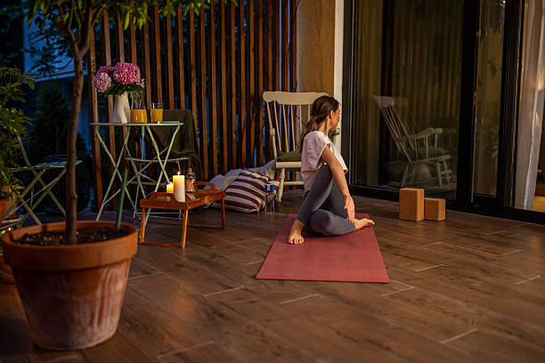 istock Woman Practicing Yoga Outdoors at Night on a Cozy Patio Setting 2239905805