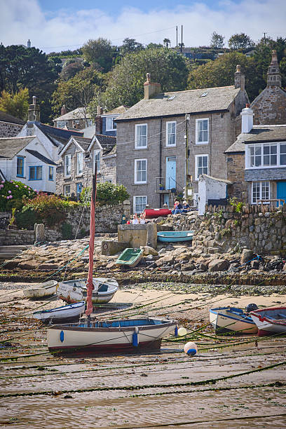 istock Mousehole Harbour an village at low tide, Cornwall, England, UK during a sunny day 2239905898
