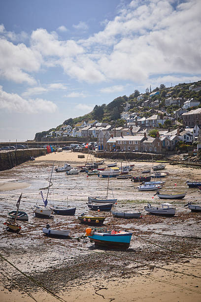 istock Mousehole Harbour an village at low tide, Cornwall, England, UK during a sunny day 2239905914