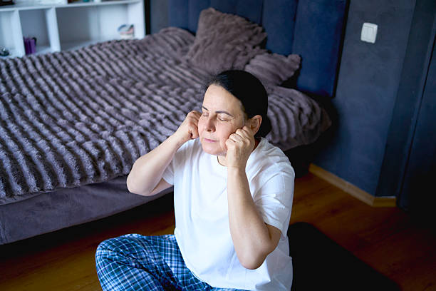 istock a senior woman performs somatic exercises, yoga at home 2239906061