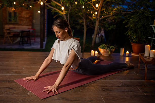 istock Woman Practicing Yoga Outdoors by Candlelight During an Evening Session 2239906126
