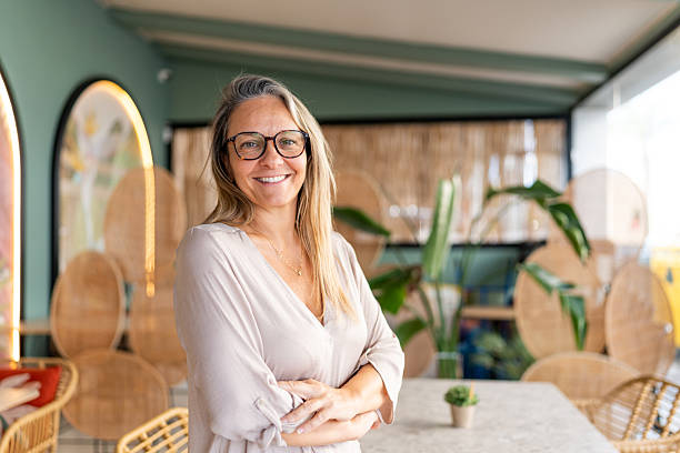 istock Confident mature woman smiling at coffee shop 2239906310