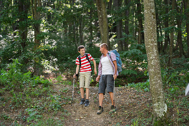 istock Father and Son Enjoying Forest Hike with Trekking Poles 2239906698