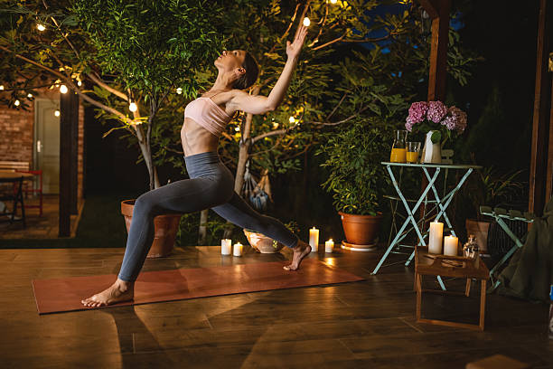 istock Woman Practicing Yoga at Night in a Peaceful Outdoor Setting 2239906718