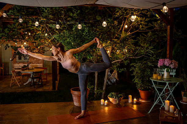 istock Woman Practicing Yoga at Night in a Peaceful Outdoor Setting 2239906754