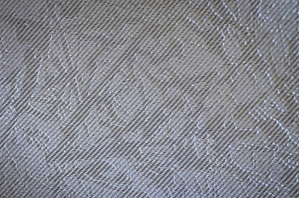 a woven fabric showcases a durable and modern twill pattern in a brownish-gray hue, perfect as a background for interior or fashion design.