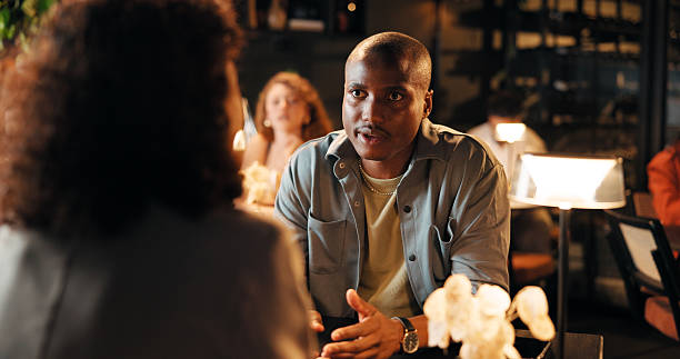 istock Talking, date and relax with man in restaurant for romantic anniversary, bonding and fine dining chat. Connection, love and marriage commitment with couple at night for dinner reservation and support 2239907722