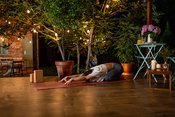 istock Outdoor Yoga Session in a Cozy Nighttime Garden Setting 2239908041