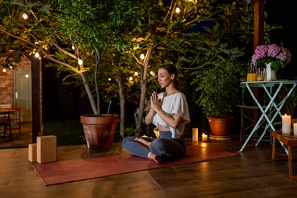 istock Serene Evening Yoga Practice in a Garden Setting With Cozy Lighting 2239908091