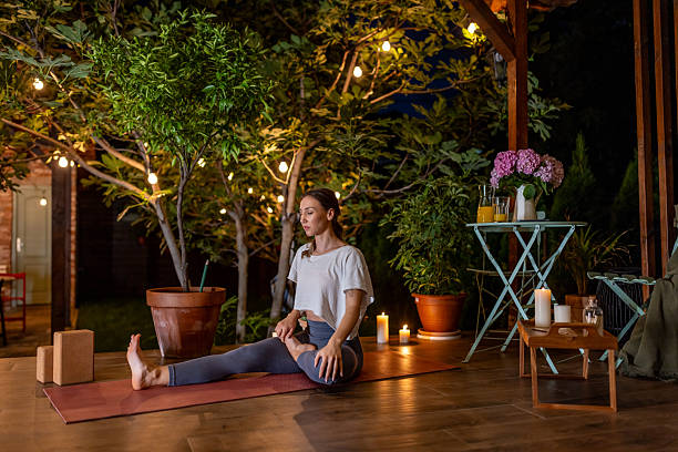 istock Meditative Yoga Practice Outdoors with Warm Evening Lighting and Candles 2239908192