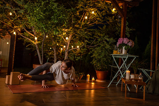 istock Woman Practicing Yoga at Night in a Peaceful Garden Setting 2239908198