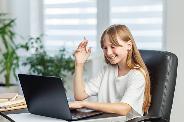 istock Happy girl waving during online video call 2239909336